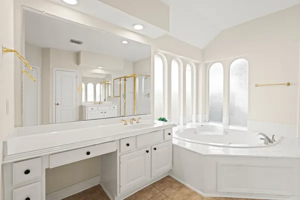 a bathroom with a double vanity sink and a bathtub