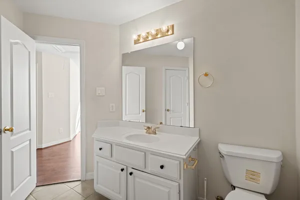 a bathroom with a sink a toilet and a mirror