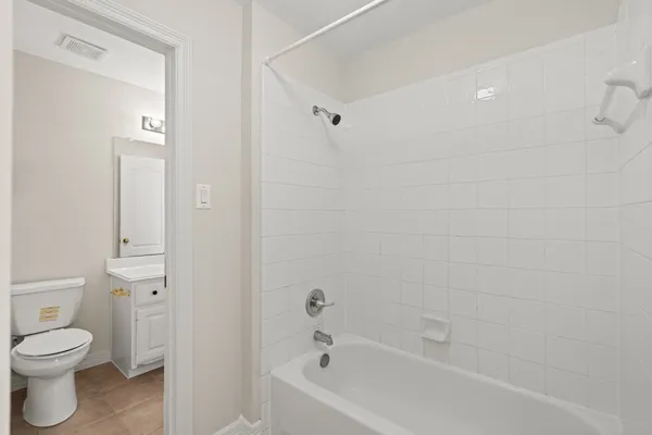 a bathroom with a toilet and a bathtub