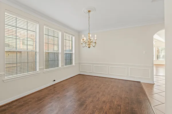 a view of wooden floor and windows in a room
