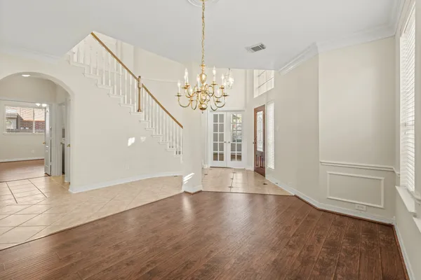 a view of a livingroom with wooden floor and chandelier