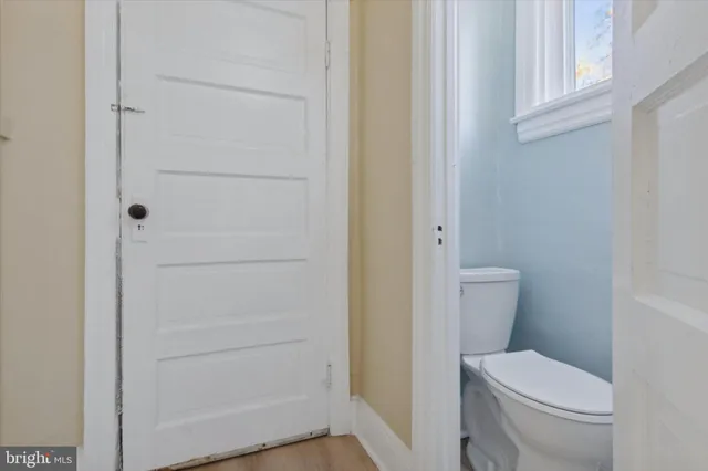 a white toilet sitting next to a shower