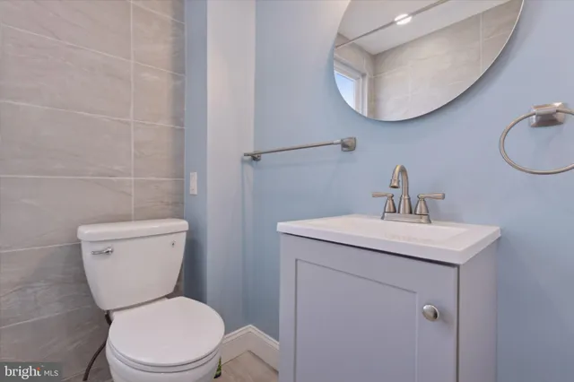 a bathroom with a toilet a sink and mirror