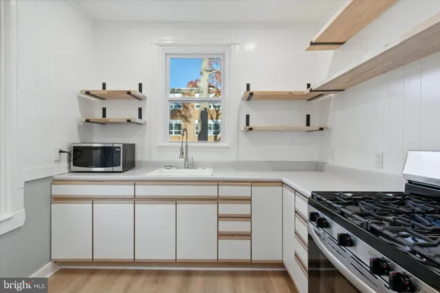 a kitchen with cabinets and appliances