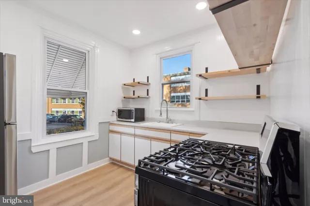a kitchen with stainless steel appliances granite countertop a stove and a refrigerator