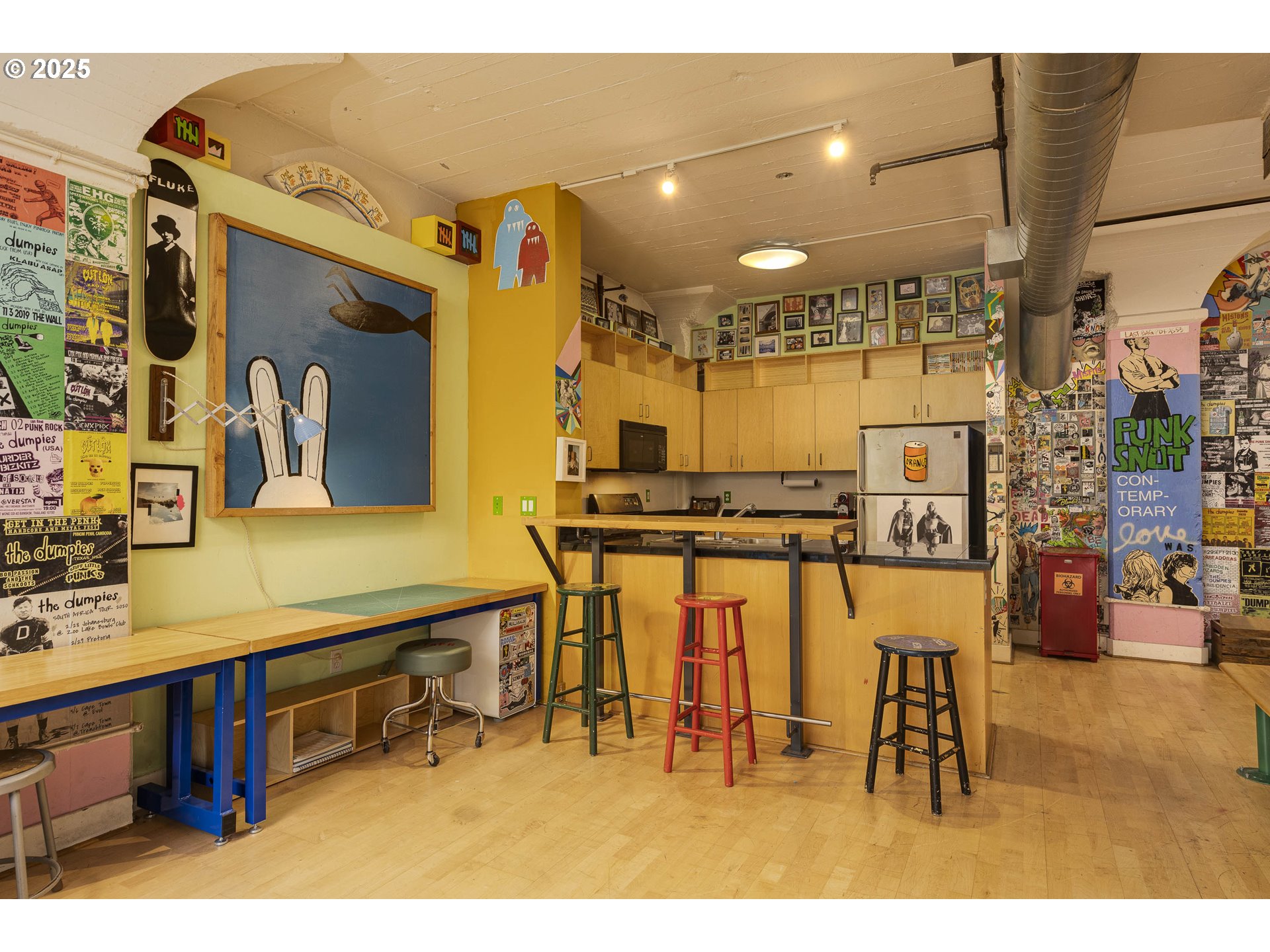 300 Northwest 8th Avenue, Unit 401 Portland, OR 97209 - Photo 11 of 37 a kitchen with stainless steel appliances kitchen island granite countertop a refrigerator and cabinets