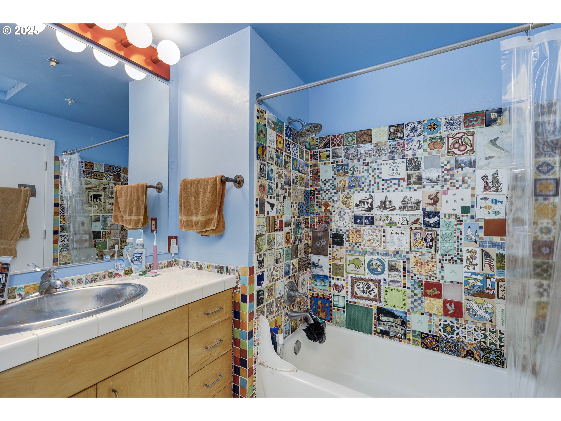 300 Northwest 8th Avenue, Unit 401 Portland, OR 97209 - Photo 19 of 37 a bathroom with a sink mirror and shower