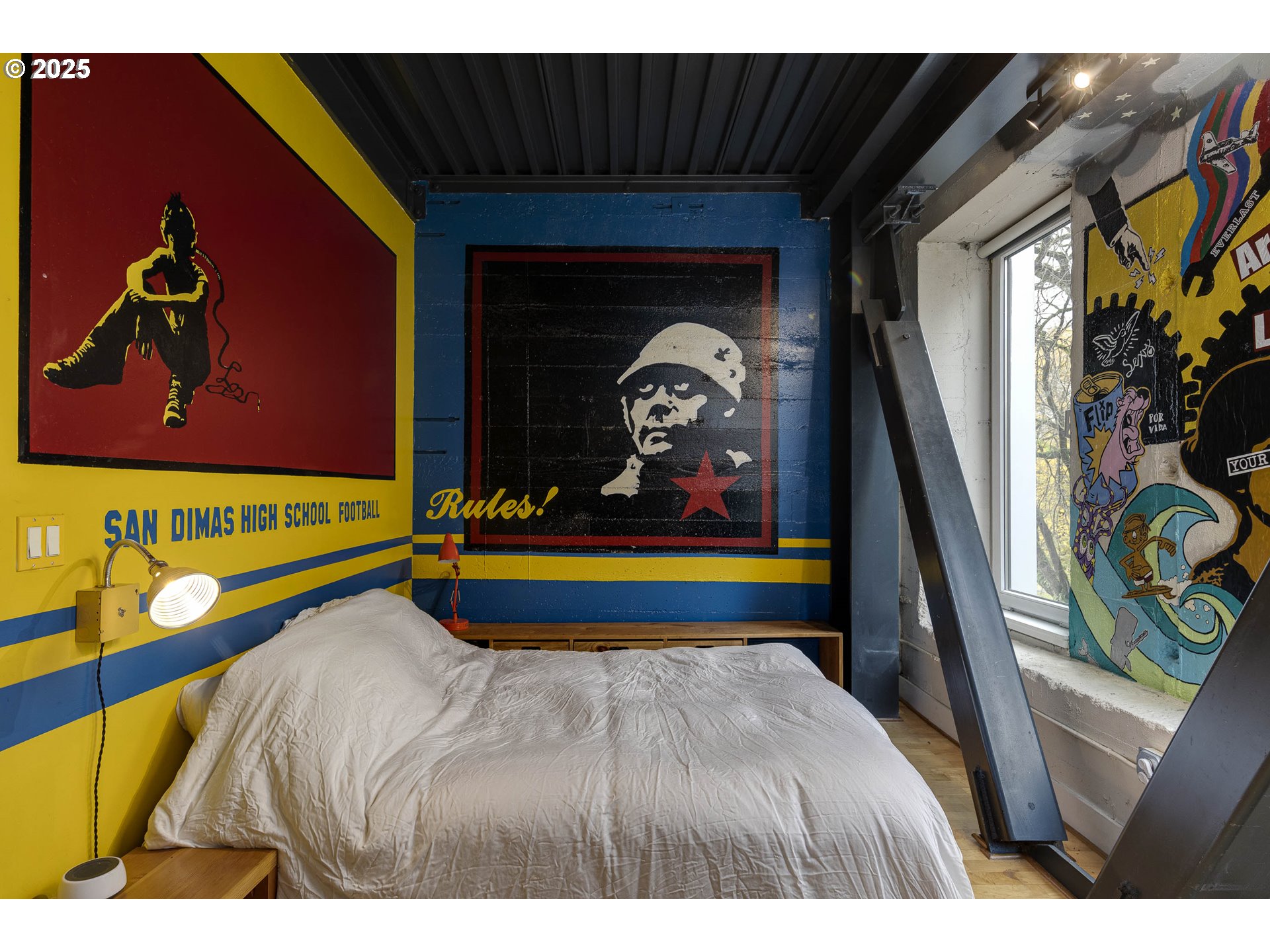 300 Northwest 8th Avenue, Unit 401 Portland, OR 97209 - Photo 8 of 37 a bed sitting in a bedroom next to a window