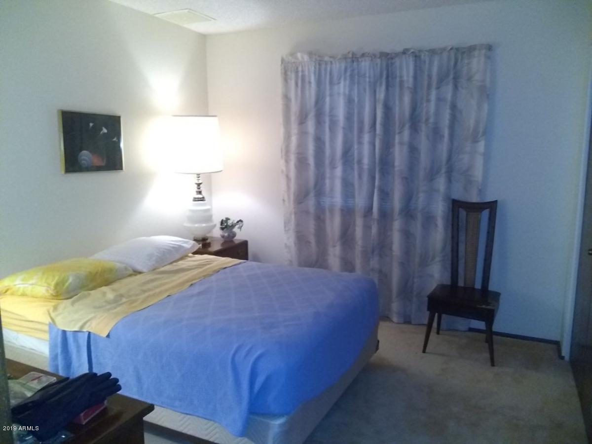 5933 East Spring Road Scottsdale, AZ 85254 - Photo 12 of 23 a bedroom with a bed and a tv on table