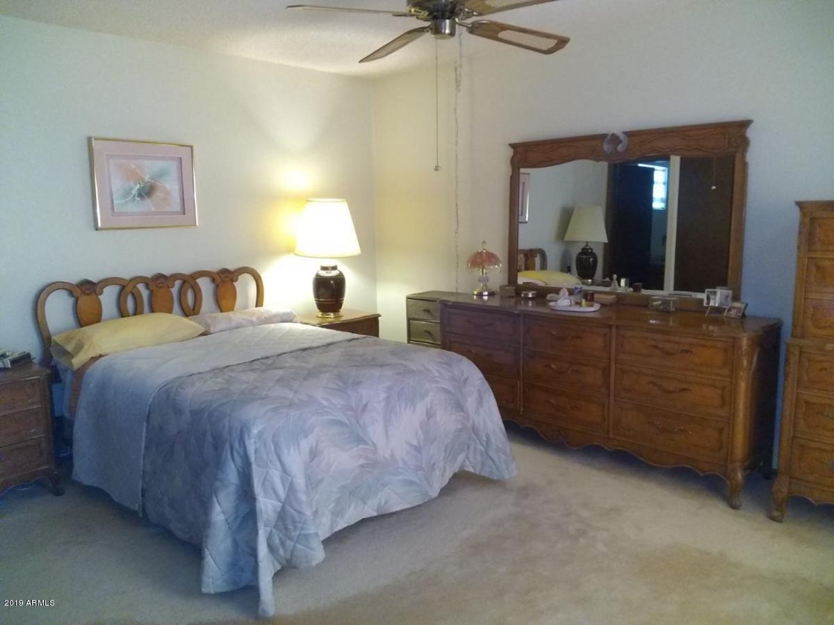 5933 East Spring Road Scottsdale, AZ 85254 - Photo 15 of 23 a bedroom with a bed and a mirror on dresser