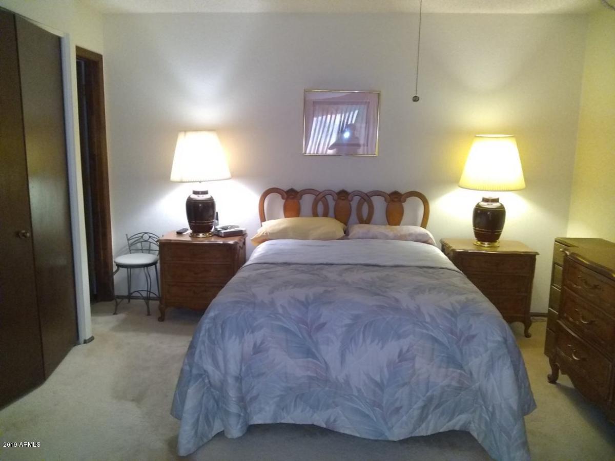 5933 East Spring Road Scottsdale, AZ 85254 - Photo 16 of 23 a bedroom with a bed and a lamp