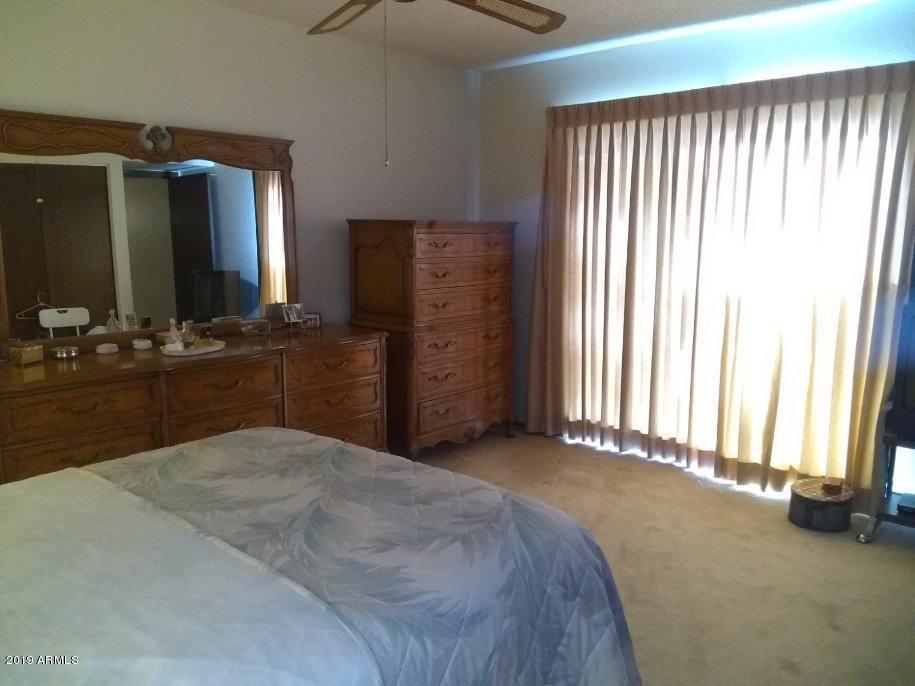 5933 East Spring Road Scottsdale, AZ 85254 - Photo 17 of 23 a spacious bedroom with a balcony a bed and a dresser in it
