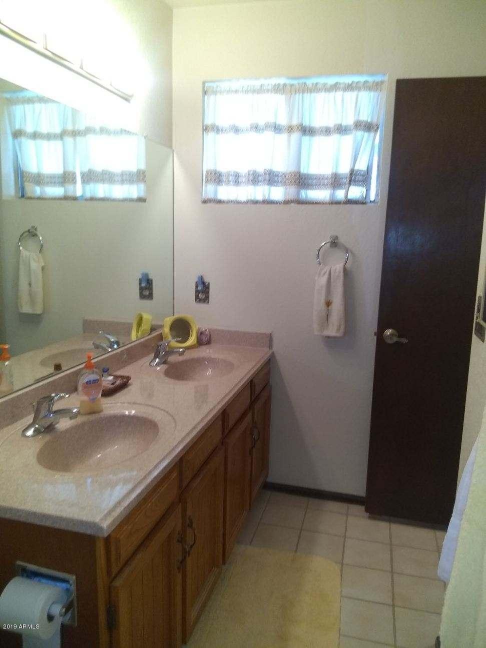 5933 East Spring Road Scottsdale, AZ 85254 - Photo 18 of 23 a bathroom with a sink and a window