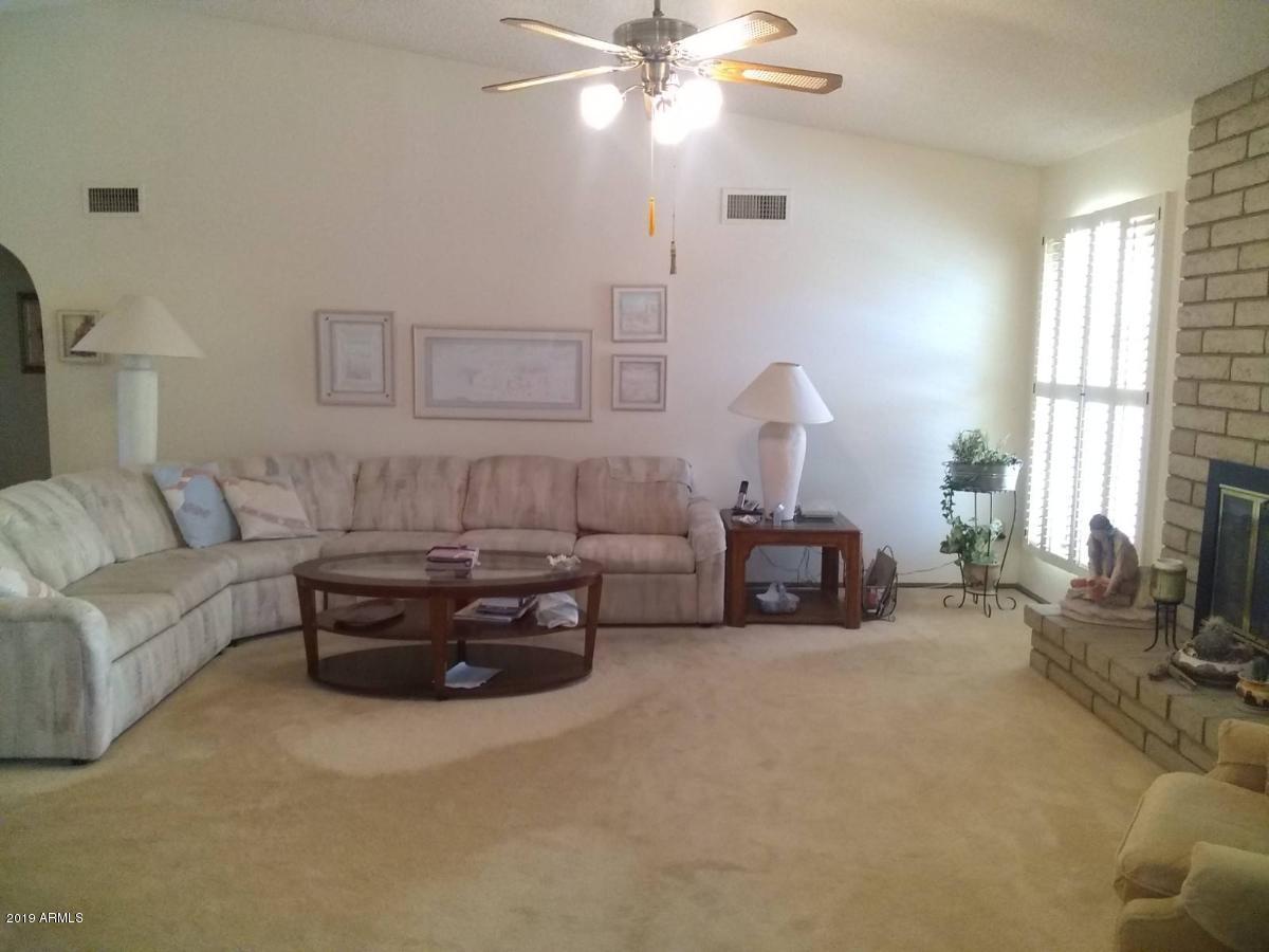 5933 East Spring Road Scottsdale, AZ 85254 - Photo 3 of 23 a living room with furniture a bed and a chandelier