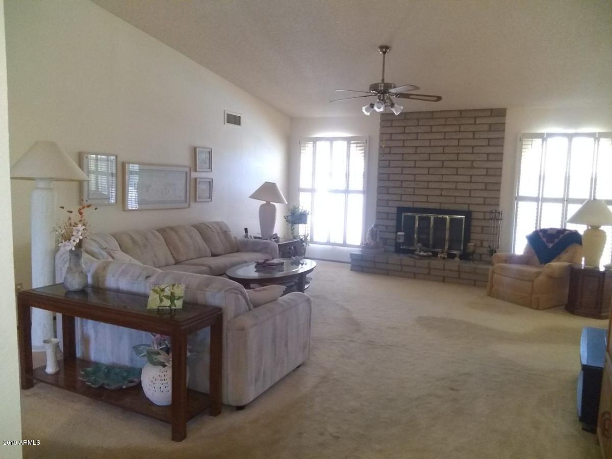 5933 East Spring Road Scottsdale, AZ 85254 - Photo 4 of 23 a living room with furniture and a fireplace