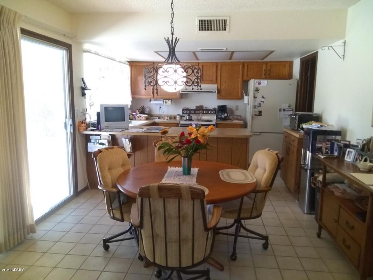5933 East Spring Road Scottsdale, AZ 85254 - Photo 8 of 23 a view of a dining room with furniture window and wooden floor