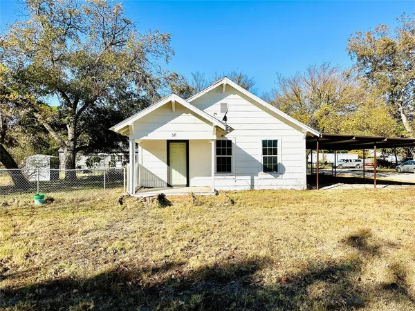 a front view of a house with swimming pool and porch