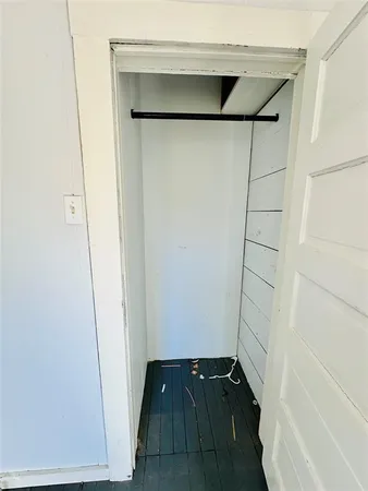 a view of walk in closet with wooden floor
