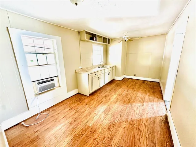 a spacious bedroom with a bed and a dresser