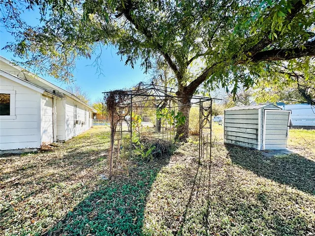 a backyard of a house with table and chairs