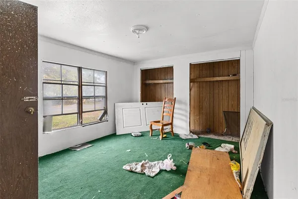 a view of a backyard with a garden and entertaining space