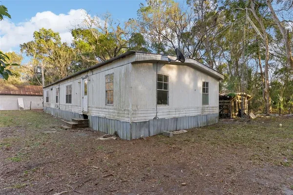 a front view of a house with a garden and deck