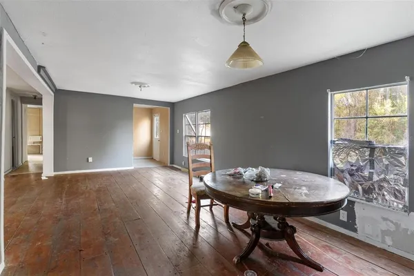 a view of a room with a table and chairs