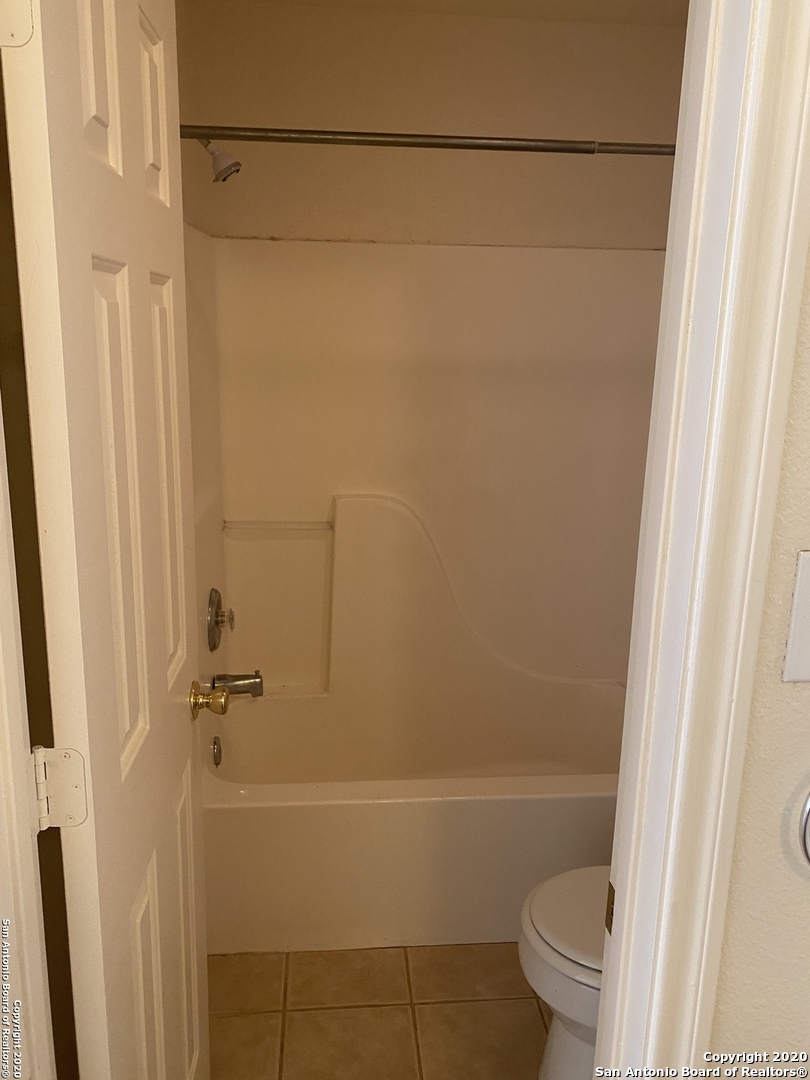 11220 Center Point Road San Antonio, TX 78233 - Photo 11 of 15 a bathroom with a shower and a toilet