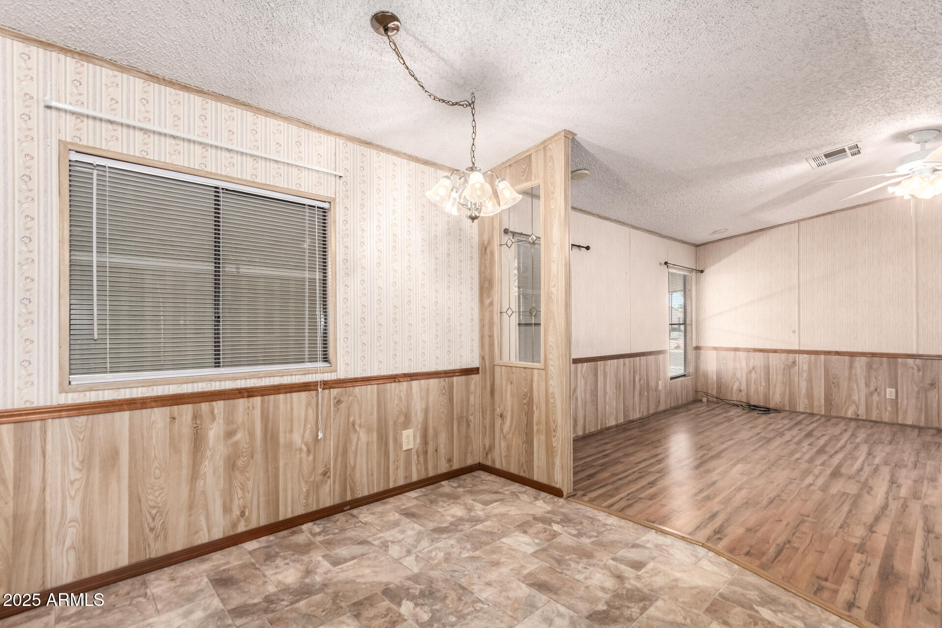 834 South Meridian Road, Unit 116 Apache Junction, AZ 85120 - Photo 11 of 42 a view of a livingroom with wooden floor and white walls