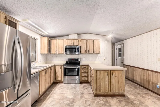 a view of a kitchen with kitchen island a sink table and chairs