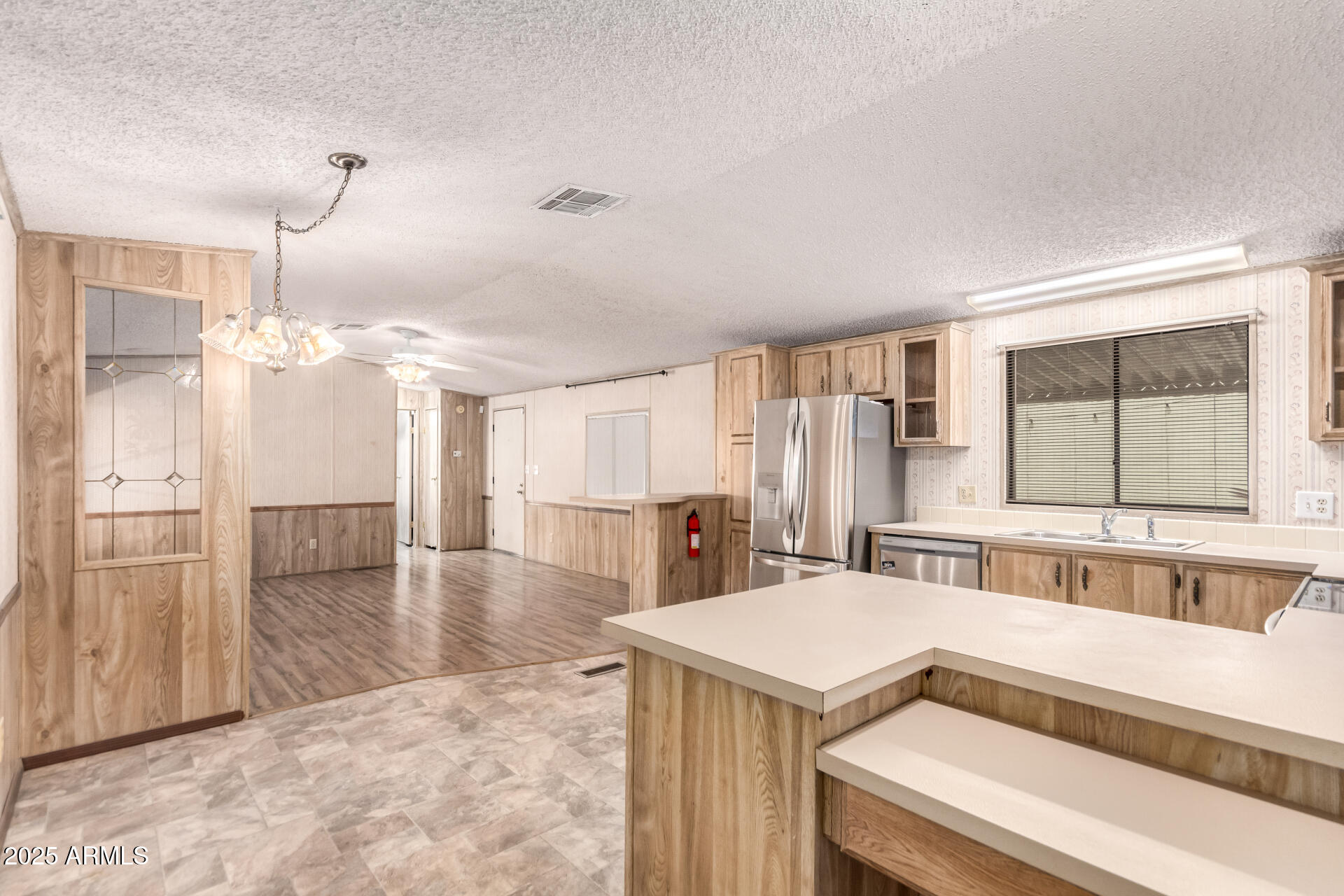 834 South Meridian Road, Unit 116 Apache Junction, AZ 85120 - Photo 15 of 42 a view of a kitchen with kitchen island a sink table and chairs