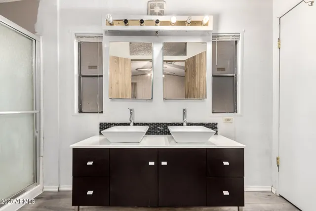 a bathroom with a glass shower door