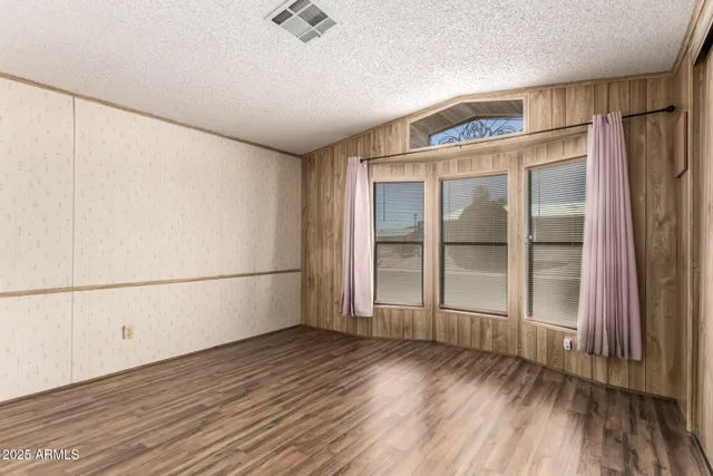 a view of a room with wooden floor and walls