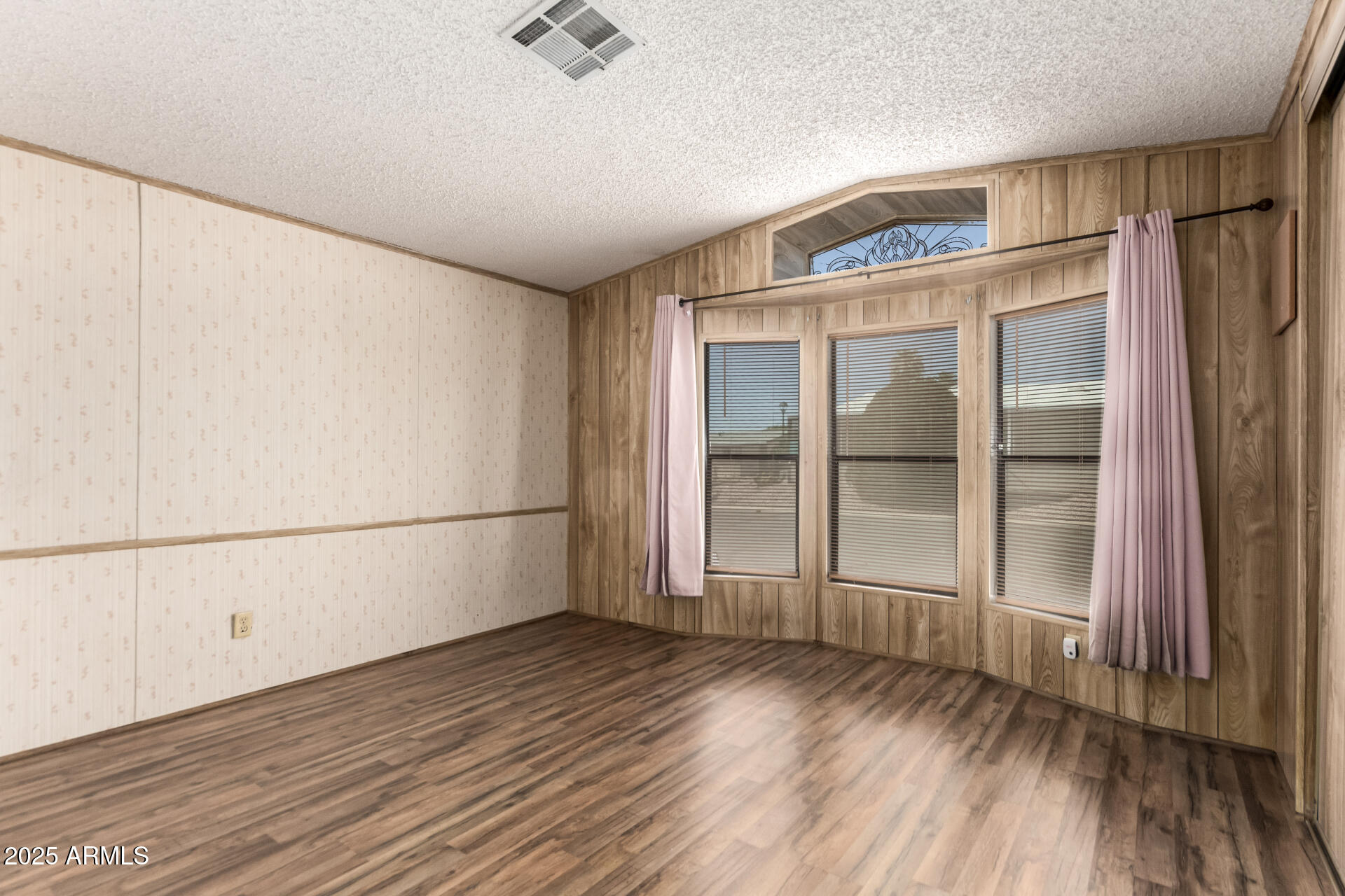 834 South Meridian Road, Unit 116 Apache Junction, AZ 85120 - Photo 22 of 42 an empty room with wooden floor and windows