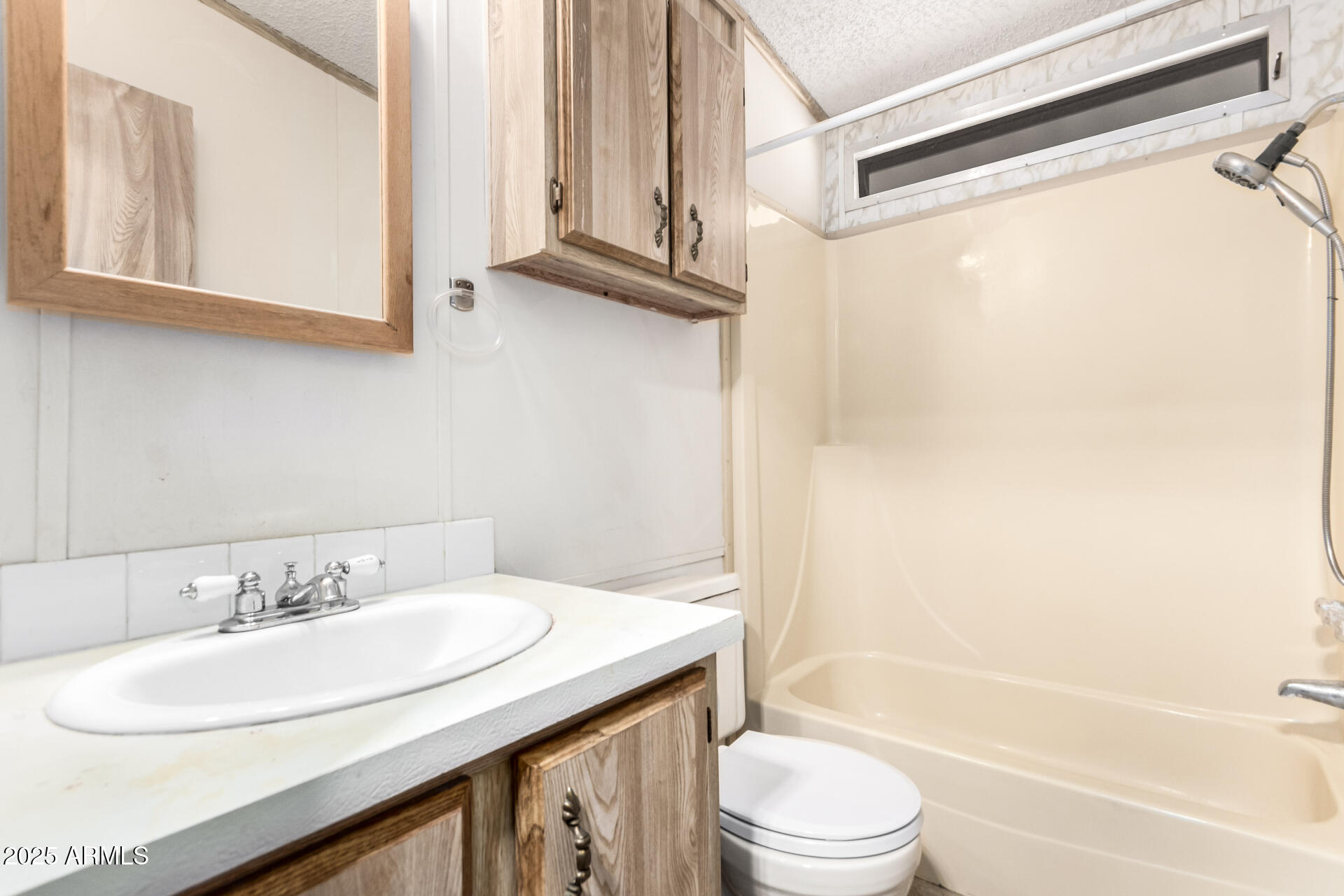 834 South Meridian Road, Unit 116 Apache Junction, AZ 85120 - Photo 24 of 42 a bathroom with a granite countertop sink toilet and a bathtub