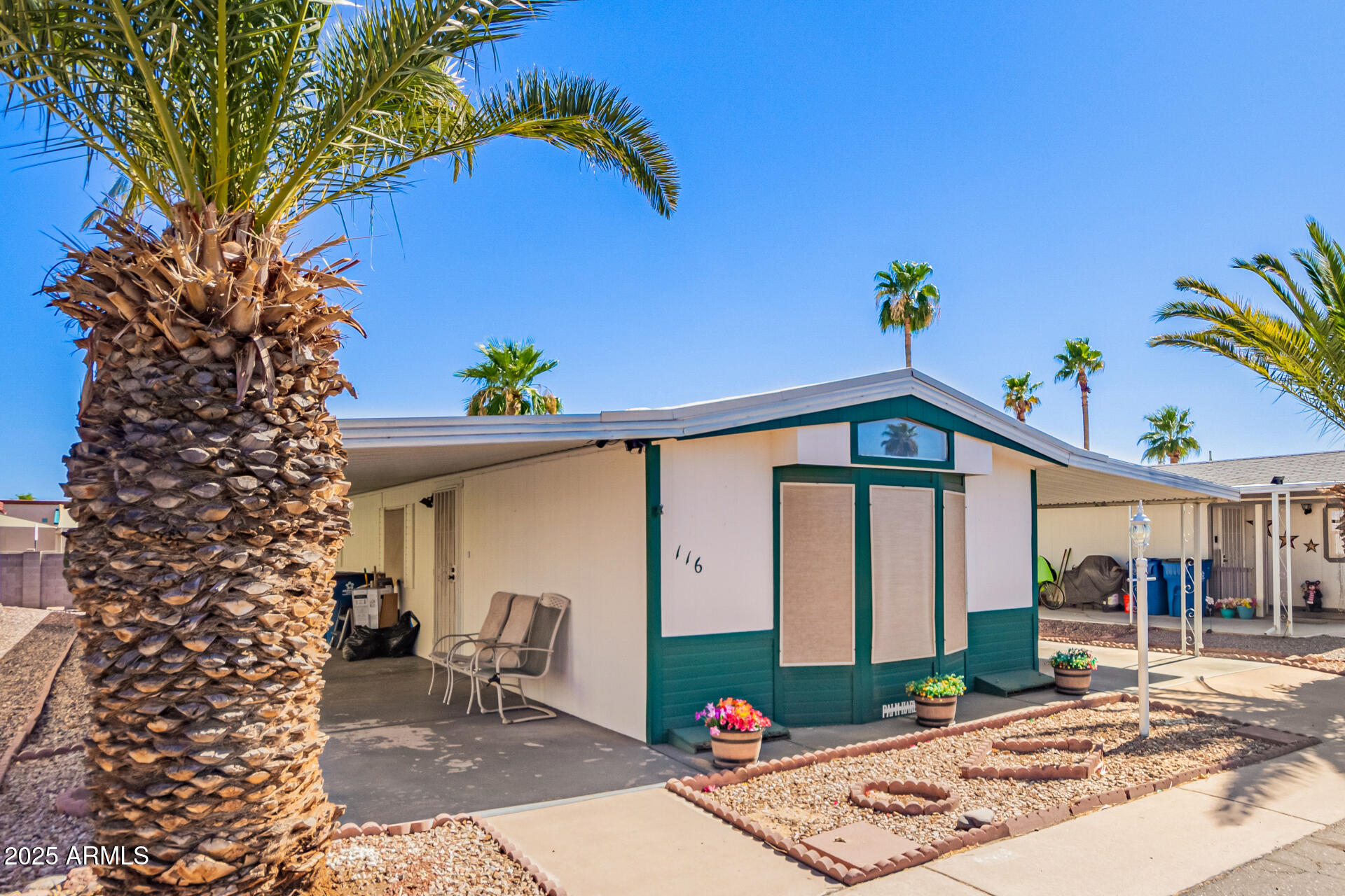 834 South Meridian Road, Unit 116 Apache Junction, AZ 85120 - Photo 4 of 42 a front view of a house with garden