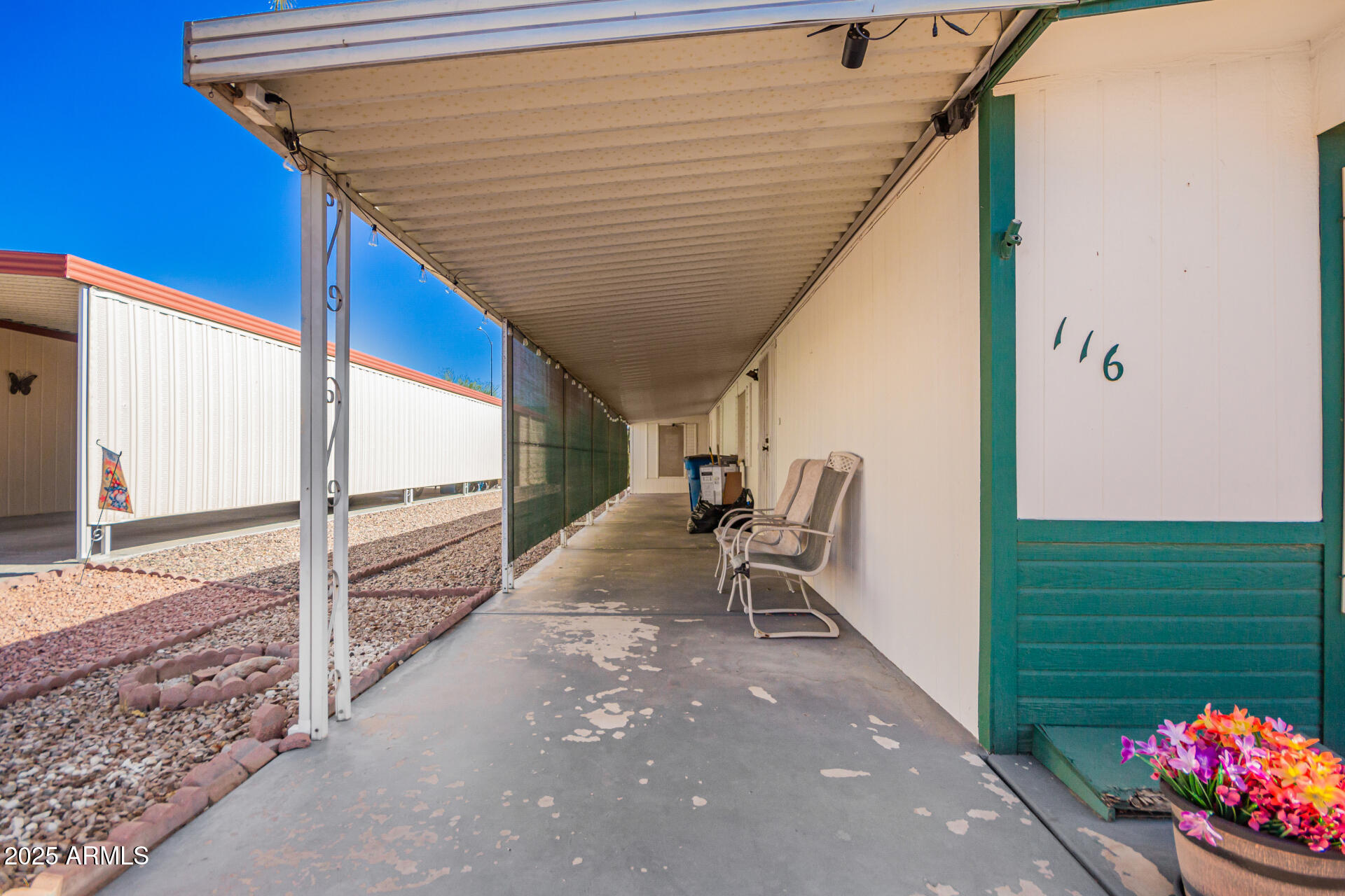 834 South Meridian Road, Unit 116 Apache Junction, AZ 85120 - Photo 7 of 42 a roof deck with table and chairs and potted plants