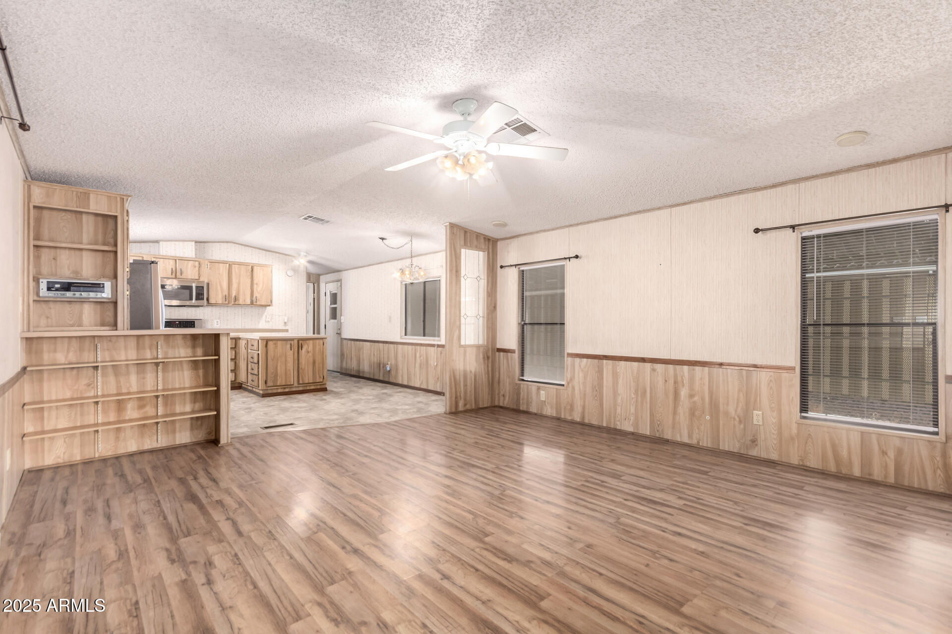 834 South Meridian Road, Unit 116 Apache Junction, AZ 85120 - Photo 8 of 42 a view of a room with wooden floor and windows