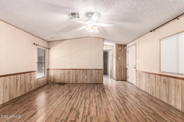 a view of a livingroom with wooden floor and white walls