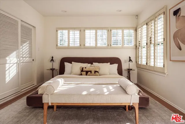 a view of a patio with couches table and chairs and potted plants