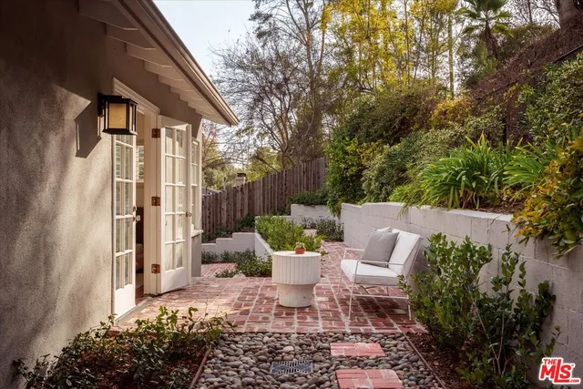 a bathroom with a granite countertop sink a large mirror and a shower