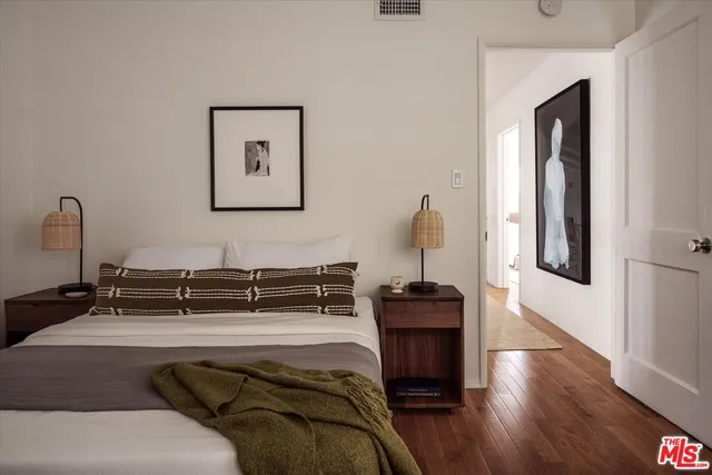 a bedroom with a bed and a large window