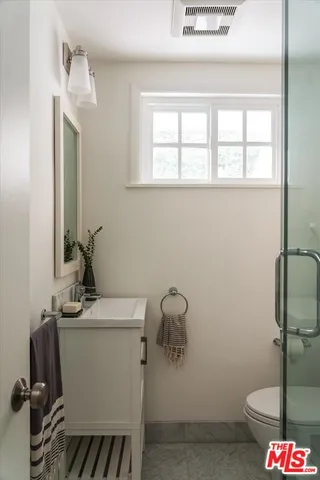 a bedroom with a bed and a view of kitchen