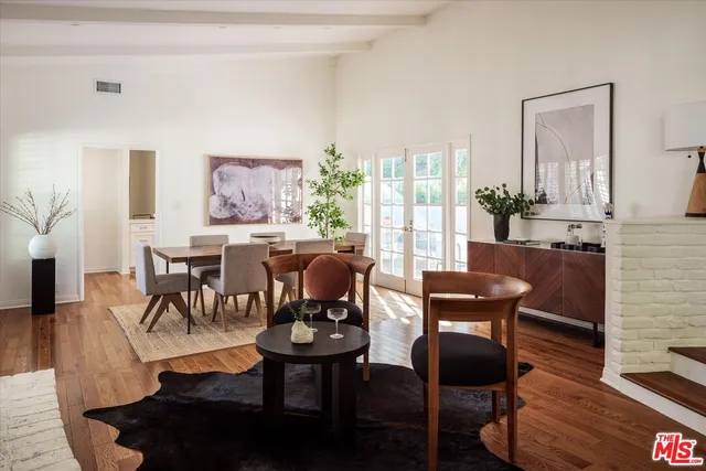a dining room with furniture and wooden floor