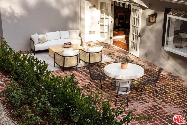 a kitchen with stainless steel appliances a sink a stove and white cabinets