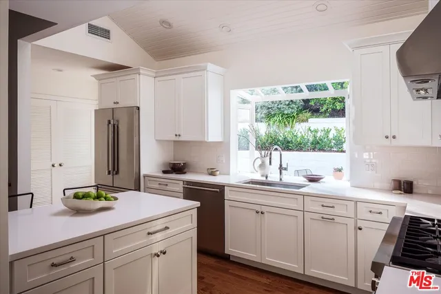 a kitchen with a stove a sink and a refrigerator