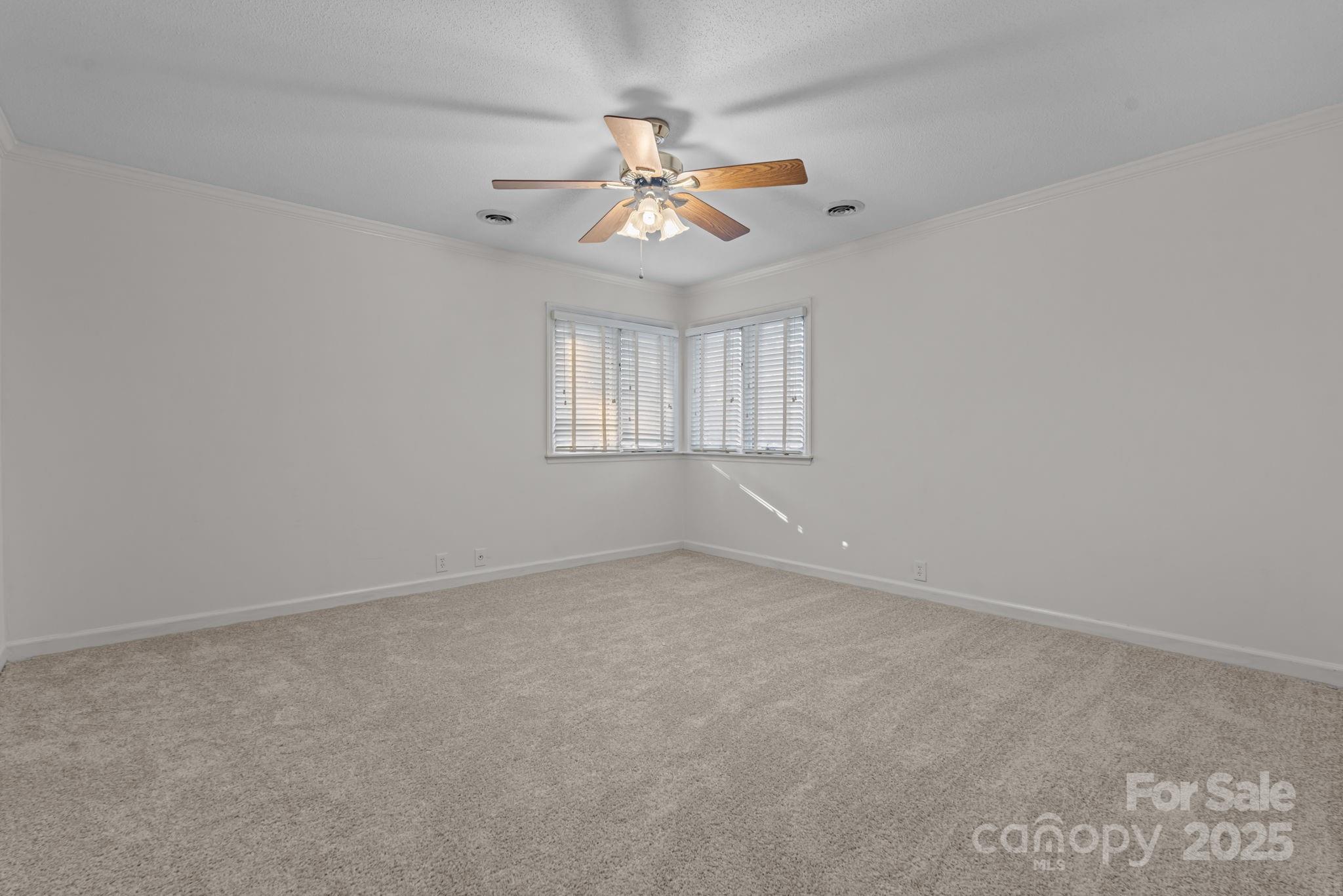 2000 Airport Road Carthage, NC 28327 - Photo 16 of 45 an empty room with windows and fan