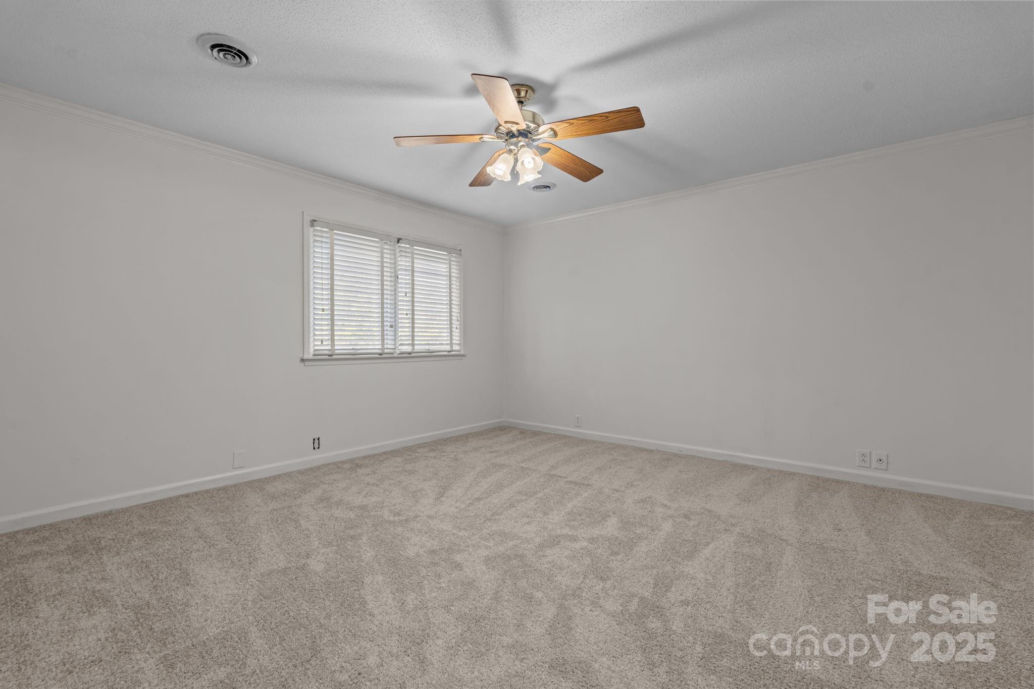 2000 Airport Road Carthage, NC 28327 - Photo 20 of 45 an empty room with a window and a fan
