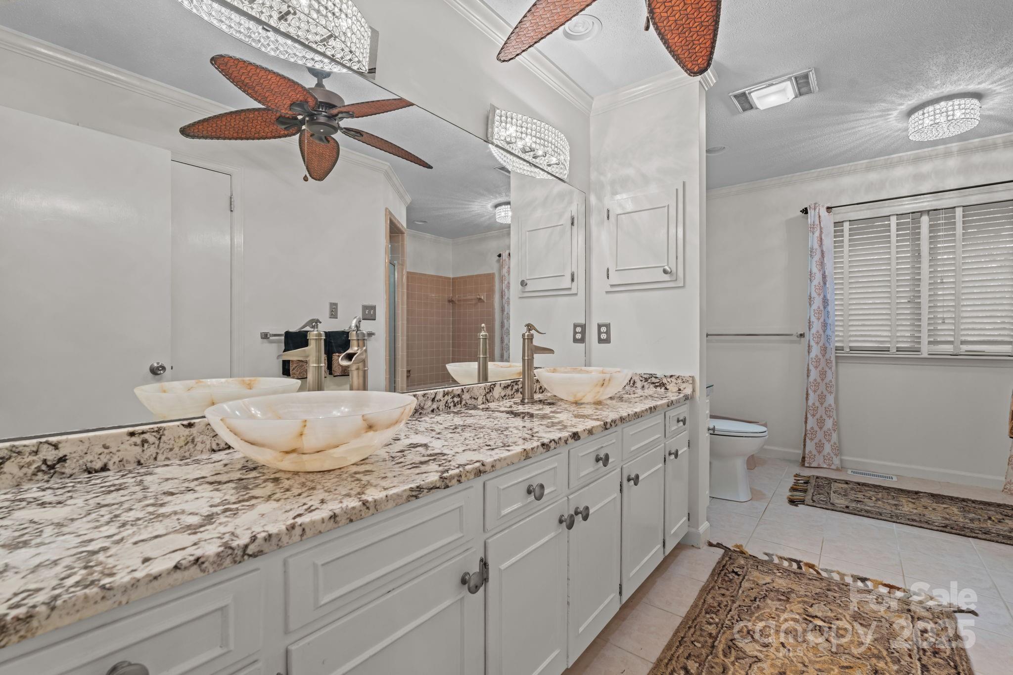 2000 Airport Road Carthage, NC 28327 - Photo 25 of 45 a bathroom with a granite countertop sink a toilet and a mirror