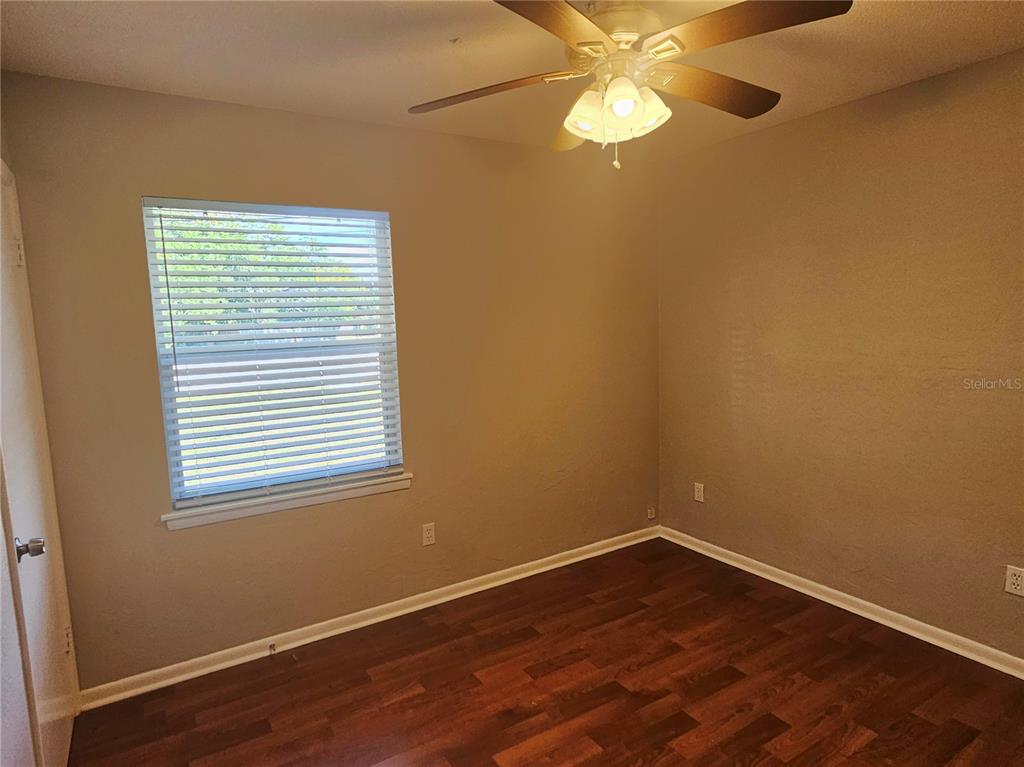 7000 Brentford Road Sarasota, FL 34241 - Photo 22 of 29 a view of an empty room with wooden floor and a window